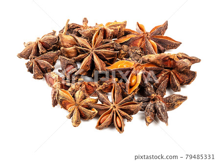 handful of star anise fruits closeup on white 79485331