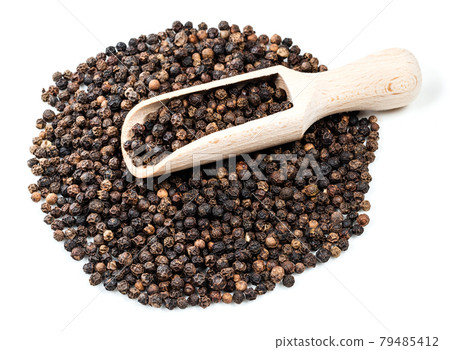 scoop on pile of black pepper peppercorns on white scoop on pile of black pepper peppercorns on white 79485412