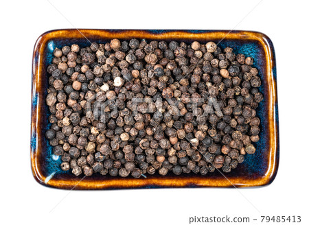 view of black pepper peppercorns in bowl cutout 79485413