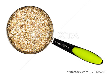 top view of quinoa seeds in measuring cup cutout 79485709