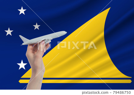 Airplane in hand with national flag of Tokelau. Travel to Tokelau Airplane in hand with national flag of Tokelau. Travel to Tokelau 79486750