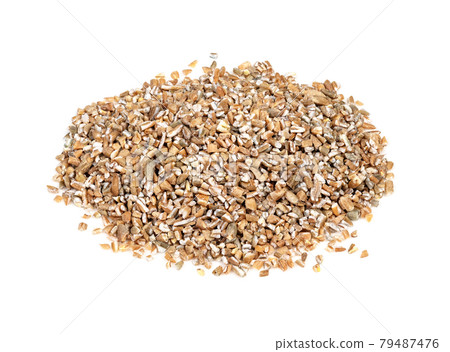 handful of crushed rye groats closeup on white 79487476