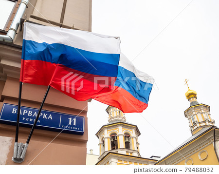 Russian state flag fluttering in wind near church 79488032
