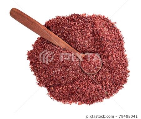 top view of wood spoon on sumac powder on white top view of wood spoon on sumac powder on white 79488041