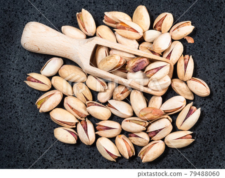 top view of wood scoop in heap of pistachio seeds top view of wood scoop in heap of pistachio seeds 79488060