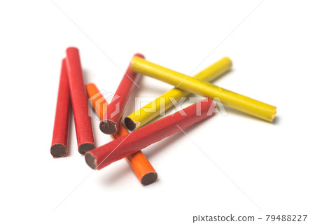 Closeup of chocolate cigarettes on white background Closeup of chocolate cigarettes on white background 79488227