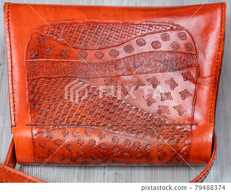 embossed pattern on back side of leather handbag 79488374