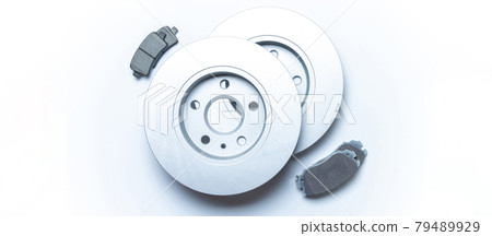 Spare parts. Auto motor mechanic spare or automotive piece on white background. New metal car part. Flat lay, top view, copy space. Spare parts. Auto motor mechanic spare or automotive piece on white background. New metal car part. Flat lay, top view, copy space. 79489929