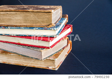 Stack of old books on dark background Stack of old books on dark background 79491230