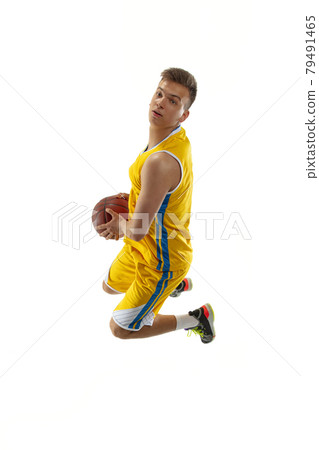 Full length portrait of a basketball player with a ball isolated on white studio background. Advertising concept. Fit Caucasian athlete jumping with ball. 79491465