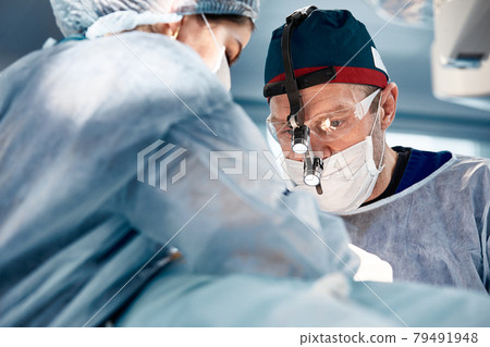 Close-up of surgeons in the operating room during the operation.Modern medicine, Medical workers during the Covid19 coronavirus pandemic fight and save lives. 79491948