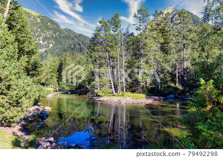 Scenic view of waterfall and lake in a Spanish Pyrenees Mountain in a sunny day. Transparent clear water.Aiguestortes i Estany of Saint Maurici National Park 79492298