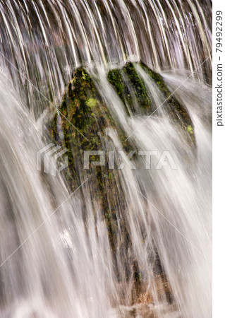 Beautiful veil cascading waterfalls, mossy rocks 79492299