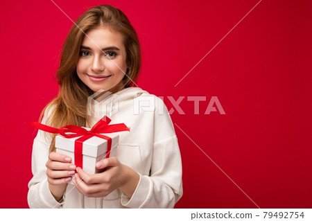 Beautiful happy young blonde woman isolated over colourful background wall wearing stylish casual 79492754