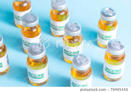 pattern from a vial with a coronavirus vaccine on a blue background. Many vials, vaccine side effects, macro pattern from a vial with a coronavirus vaccine on a blue background. Many vials, vaccine side effects, macro 79495438