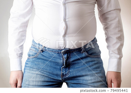 A fat man in a small, tight white shirt. Uncomfortable clothing concept, obesity. Slimming A fat man in a small, tight white shirt. Uncomfortable clothing concept, obesity. Slimming 79495441