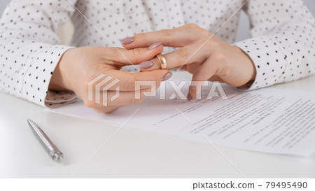 Close-up woman signed divorce papers and took off her wedding ring 79495490