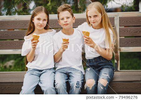 Happy children sitting together close and smile 79496276