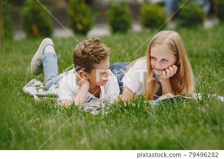 Happy children sitting together close and smile 79496282