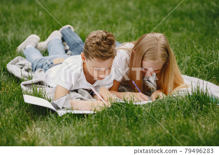 Happy children sitting together close and smile 79496283