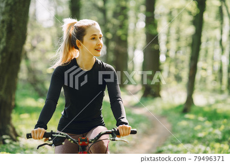 Woman riding a mountain bike in the forest 79496371