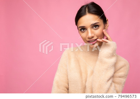 Photo of young beautiful happy cute brunette woman wearing beige jersey . Sexy carefree female 79496573