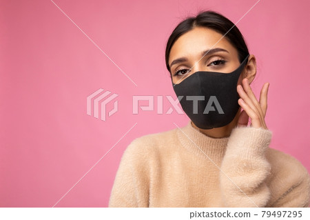 Young beautiful woman in reusable virus protective mask on face against coronavirus isolated on the 79497295