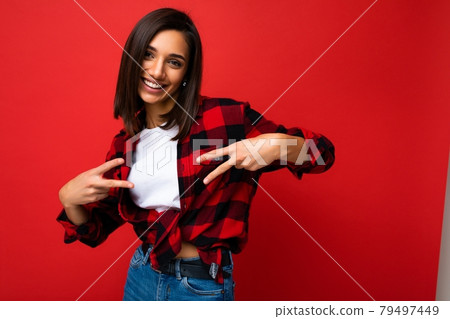 Young happy positive cool pretty brunette woman with sincere emotions wearing white t-shirt and 79497449