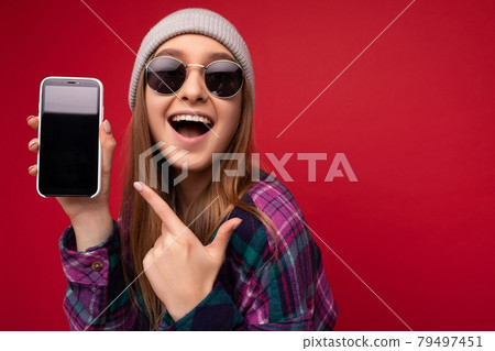 Closeup photo of attractive smiling positive young blonde woman wearing stylish purple shirt and 79497451
