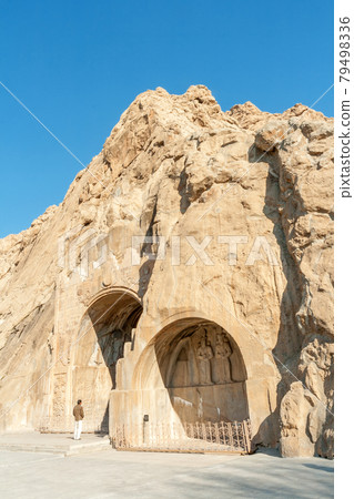 Taq Bostan or also Taq-e Bostan, Carved into the rock, place with a several reliefs from the era of Sassanid Empire of Persia. Winter season, shortly after sunrise. Taq Bostan or also Taq-e Bostan, Carved into the rock, place with a several reliefs from the era of Sassanid Empire of Persia. Winter season, shortly after sunrise. 79498336
