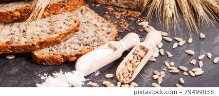 Wholegrain bread for breakfast, ingredients for baking and ears of rye or wheat grain Wholegrain bread for breakfast, ingredients for baking and ears of rye or wheat grain 79499038