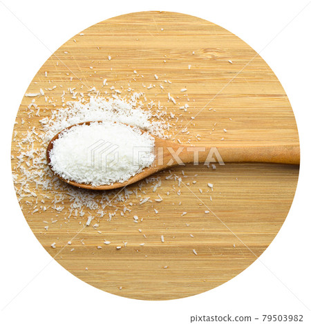 Ground fresh coconut in wooden spoon on bamboo cutting board 79503982