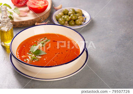 A plate of traditional spanish gazpacho in the background ingredients 79507726
