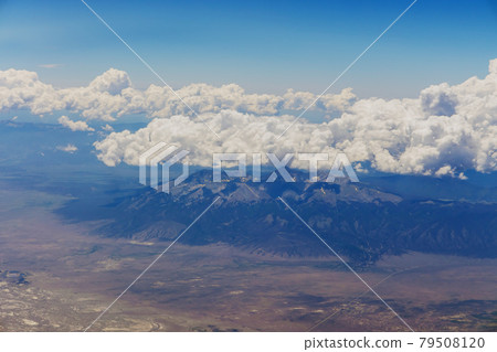 The view from the plane of fluffy clouds in mountains from an airplane, Arizona USA The view from the plane of fluffy clouds in mountains from an airplane, Arizona USA 79508120