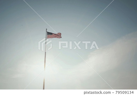 American flag against the summer evening sky American flag against the summer evening sky 79509134
