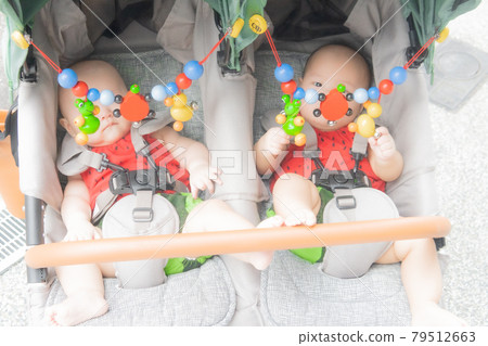 Twin babies in a stroller Twin babies in a stroller 79512663