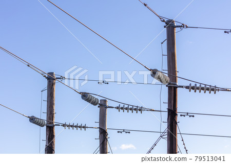 Photograph of a wooden telephone post and cables Photograph of a wooden telephone post and cables 79513041