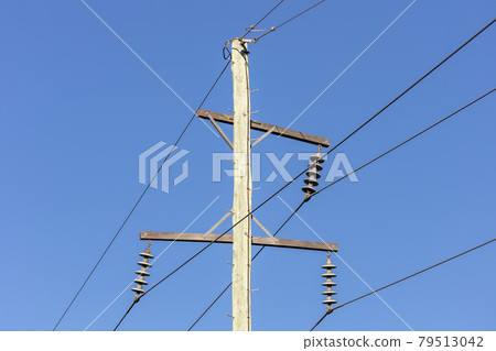Photograph of a wooden telephone post and cables Photograph of a wooden telephone post and cables 79513042