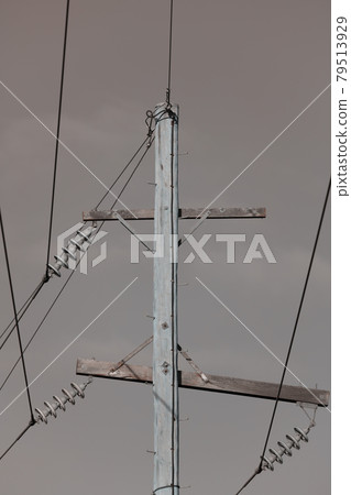Photograph of a wooden telephone post and cables Photograph of a wooden telephone post and cables 79513929