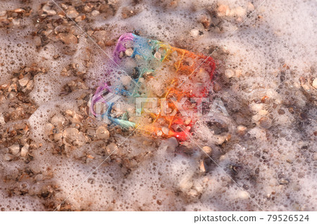 sea water and foam covered the Pop it toy.  79526524