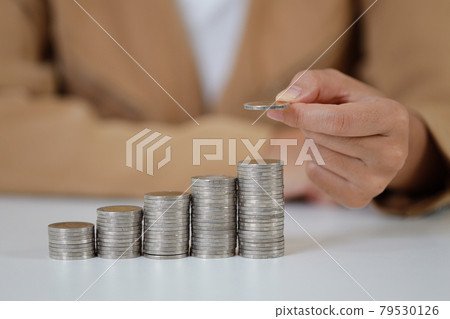 Smart and active asian businesswoman hands holding on stacking coin growing on white table and white background, meaning of earning money or investment or tax for business advertising concept Smart and active asian businesswoman hands holding on stacking coin growing on white table and white background, meaning of earning money or investment or tax for business advertising concept 79530126