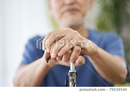 Hands of an elderly person sitting with a cane Hands of an elderly person sitting with a cane 79530594