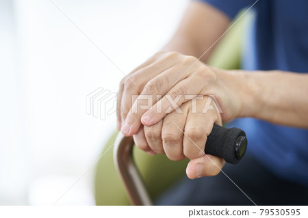 Hands of an elderly person sitting with a cane Hands of an elderly person sitting with a cane 79530595