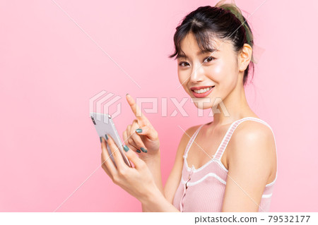 Young woman looking at a smartphone 79532177
