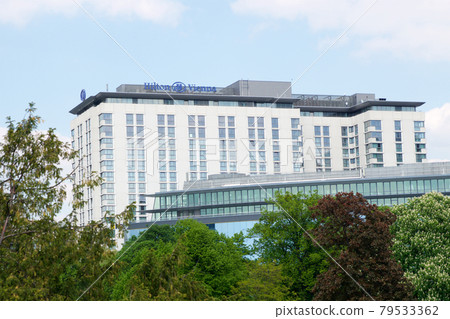 VIENNA, AUSTRIA - APR 30th, 2017: Outside view of the Hilton Vienna Hotel in Wien during nice weather with blue sky, five Star Hotel Hilton Near the green City Park 79533362