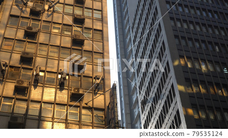 Golden sun reflection through highrise on Hong Kong old residence building cityscape beauty Golden sun reflection through highrise on Hong Kong old residence building cityscape beauty 79535124