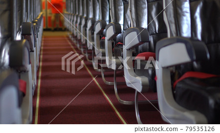 Empty passenger seat rows in plane panning shot airline business problem from panemic Empty passenger seat rows in plane panning shot airline business problem from panemic 79535126