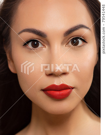 Closeup portrait of a woman with developing straight hair. Sweet tender young girl, brunette. Red lipstick on the lips, transparent transparent skin. Beauty, spa, injections, cosmetology, beautiful 79541448