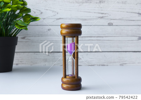 Hourglass as time passing concept for business deadline and running out of time Hourglass as time passing concept for business deadline and running out of time 79542422
