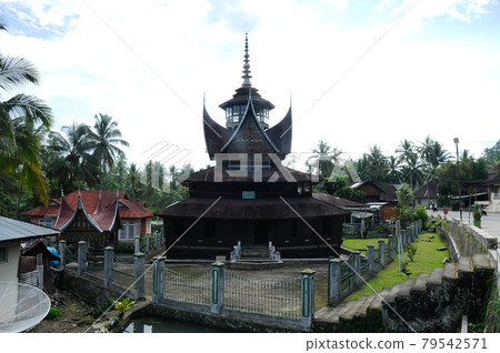 SUMATERA, INDONESIA -JUNE 10, 2014: Facade of Surau Nagari Lubuk Bauk at Tanah Datar, Sumatera Barat, Indonesia. It was a place for muslim to perform prayer and religious activity since 1901. SUMATERA, INDONESIA -JUNE 10, 2014: Facade of Surau Nagari Lubuk Bauk at Tanah Datar, Sumatera Barat, Indonesia. It was a place for muslim to perform prayer and religious activity since 1901. 79542571